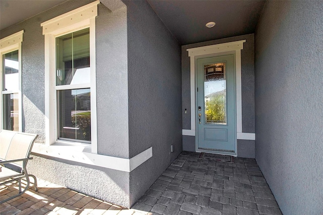 doorway to property with stucco siding