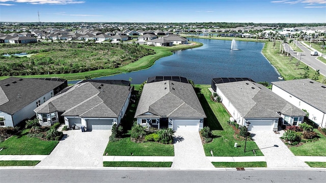 drone / aerial view featuring a residential view and a water view