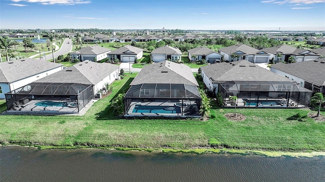 birds eye view of property with a residential view and a water view