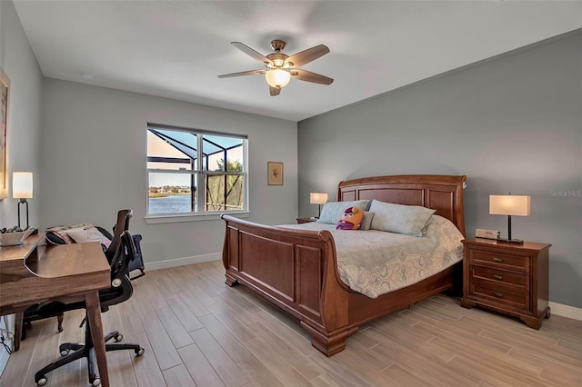 bedroom with a ceiling fan, baseboards, and light wood-type flooring