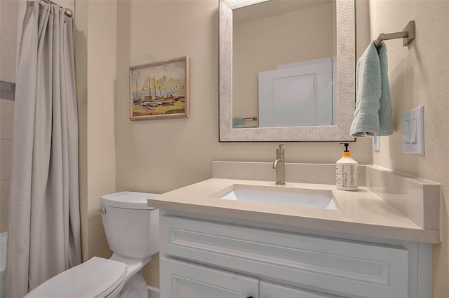 bathroom featuring toilet, vanity, and shower / bath combo