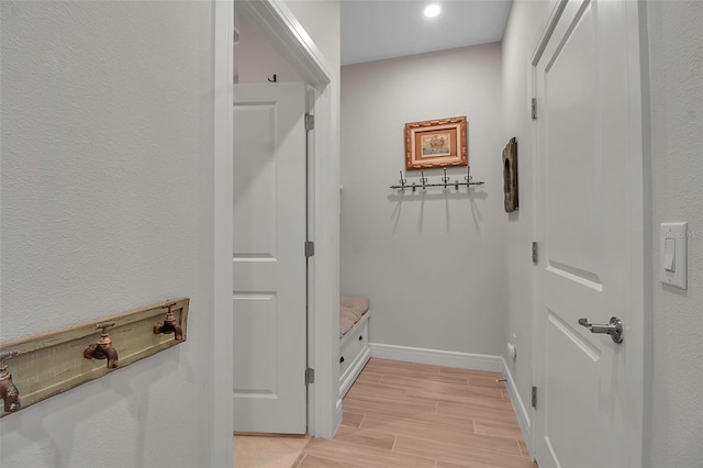 mudroom featuring baseboards and wood finish floors