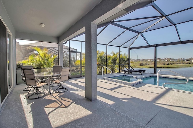 view of pool with glass enclosure, a patio, and a pool with connected hot tub