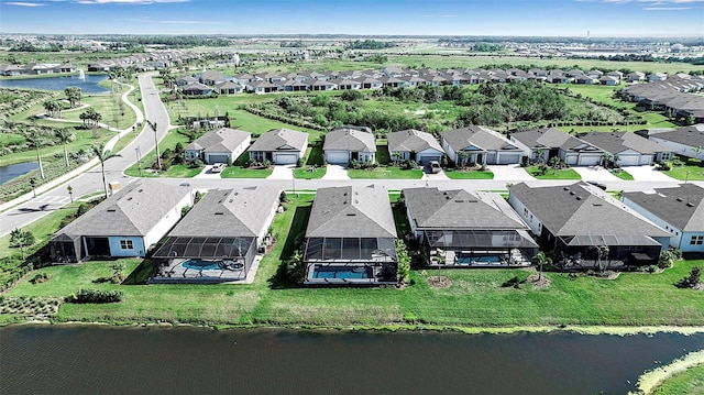 drone / aerial view featuring a residential view and a water view