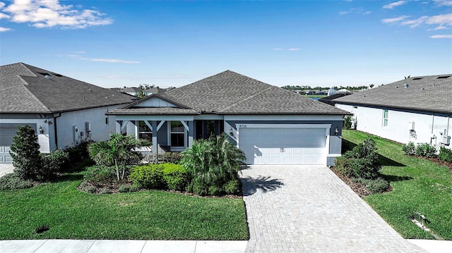 8726 Backshore Ln, Parrish, FL 34219 - single story home with stucco siding, an attached garage, decorative driveway, and a front yard