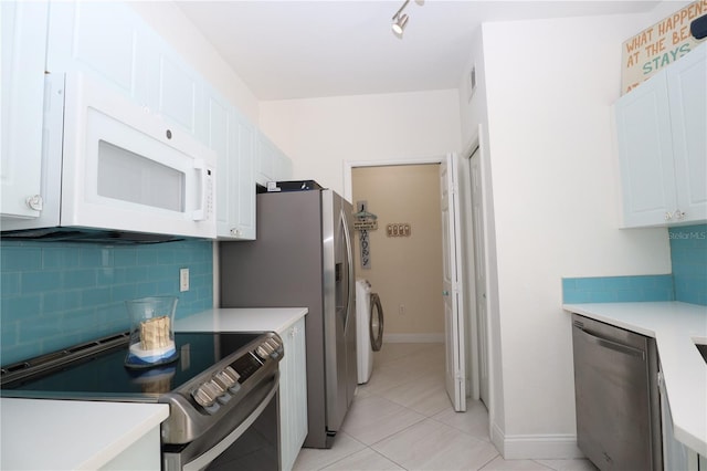 kitchen with white cabinetry, light countertops, backsplash, and stainless steel appliances