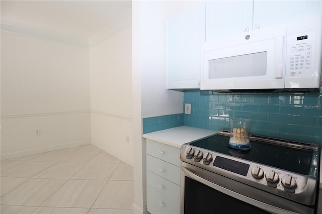 kitchen with stainless steel electric range oven, white microwave, ornamental molding, light countertops, and backsplash