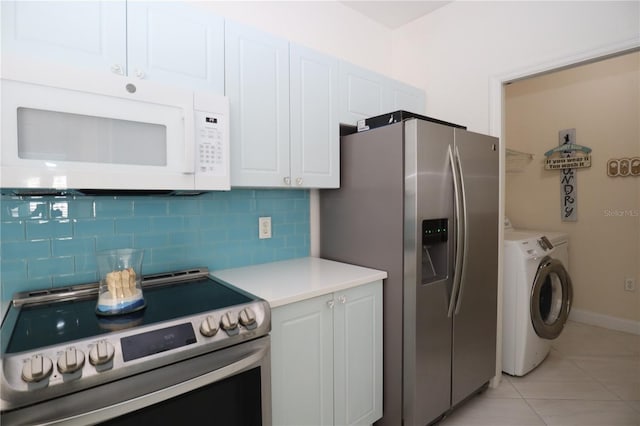 kitchen featuring backsplash, washing machine and dryer, stainless steel appliances, light countertops, and light tile patterned floors