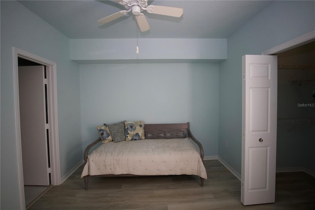 bedroom with a ceiling fan, baseboards, and wood finished floors