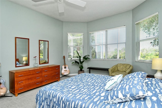 bedroom featuring ceiling fan, baseboards, and light carpet