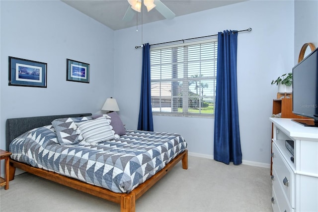 bedroom with light colored carpet and baseboards