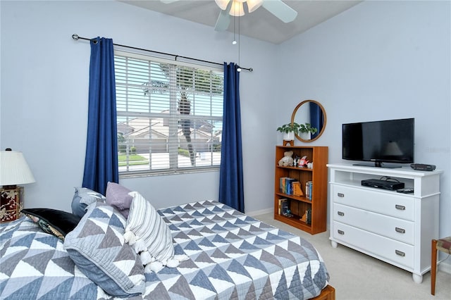 bedroom with light colored carpet and a ceiling fan