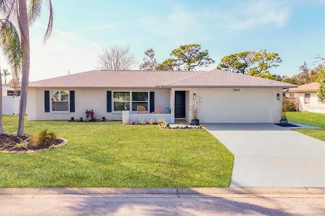 single story home with concrete driveway, roof with shingles, a front yard, stucco siding, and a garage