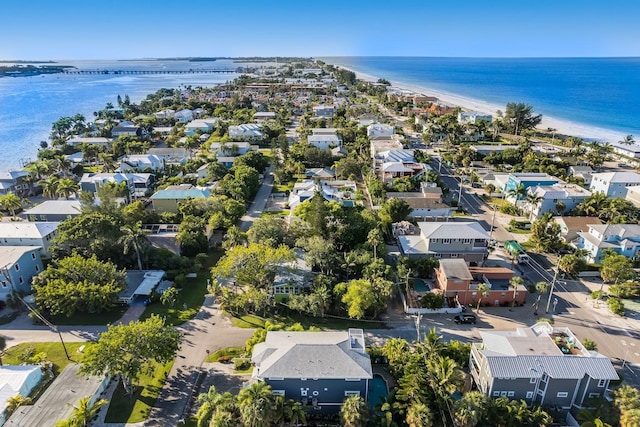 bird's eye view with a view of the beach, a water view, and a residential view