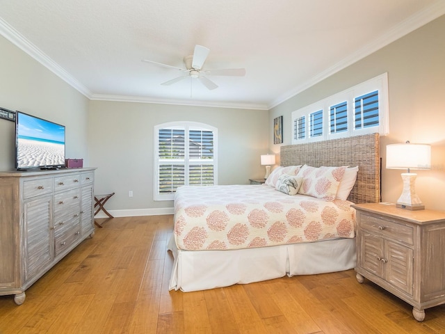 bedroom with crown molding, baseboards, light wood-type flooring, and ceiling fan