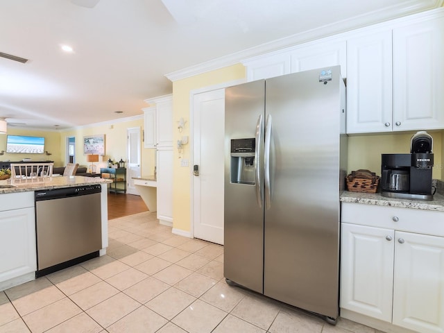 kitchen with white cabinets, visible vents, appliances with stainless steel finishes, and ornamental molding