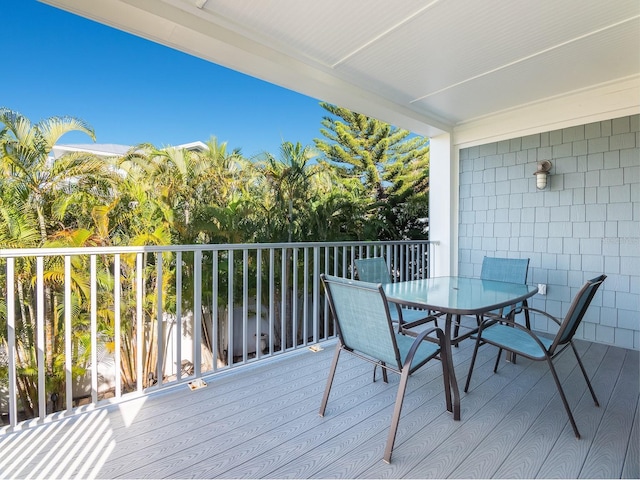 wooden deck featuring outdoor dining area