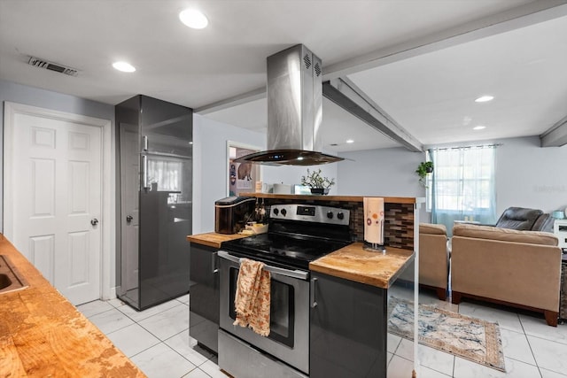 kitchen with electric range, visible vents, island exhaust hood, wood counters, and open floor plan