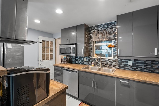 kitchen with a sink, stainless steel appliances, and gray cabinets