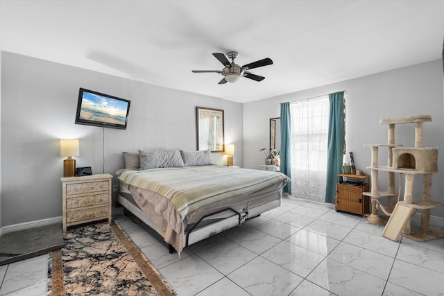 bedroom featuring marble finish floor and ceiling fan