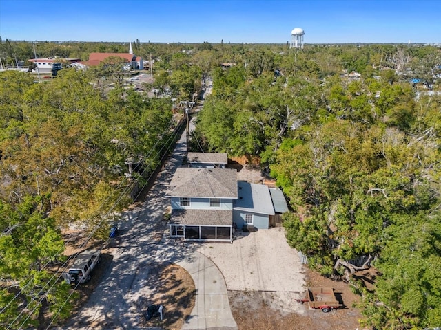 birds eye view of property featuring a wooded view