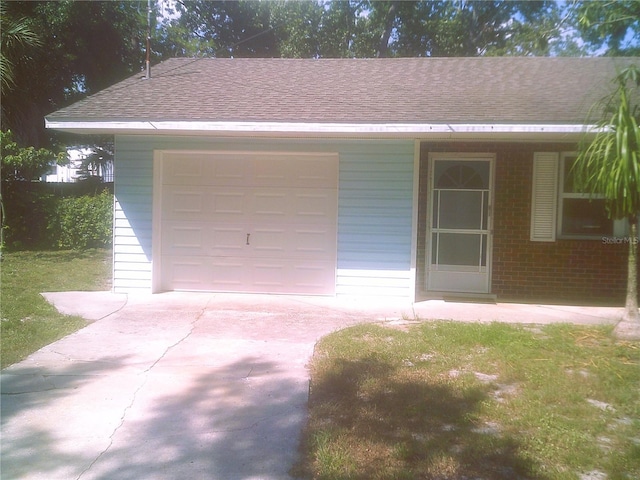 garage featuring concrete driveway