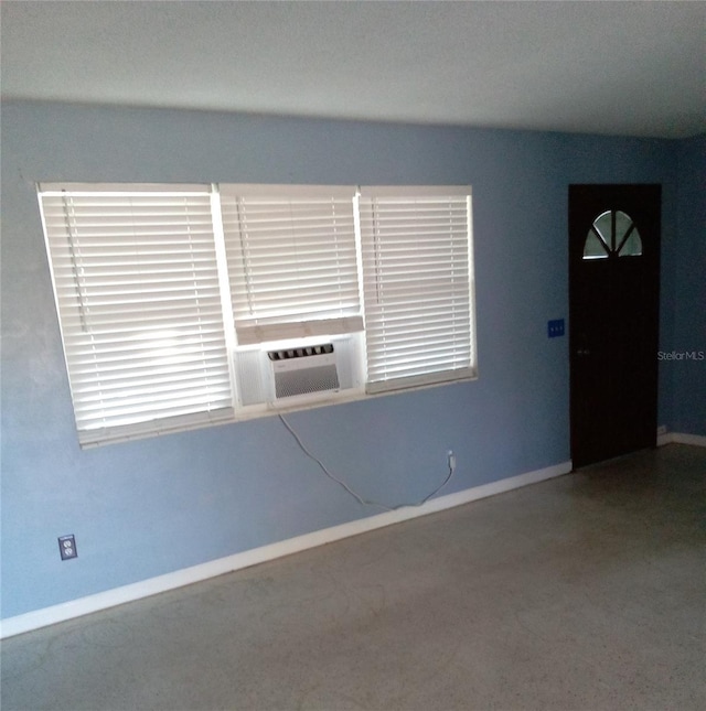 empty room with cooling unit and baseboards