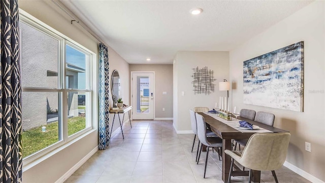 dining room featuring light tile patterned floors, baseboards, and recessed lighting