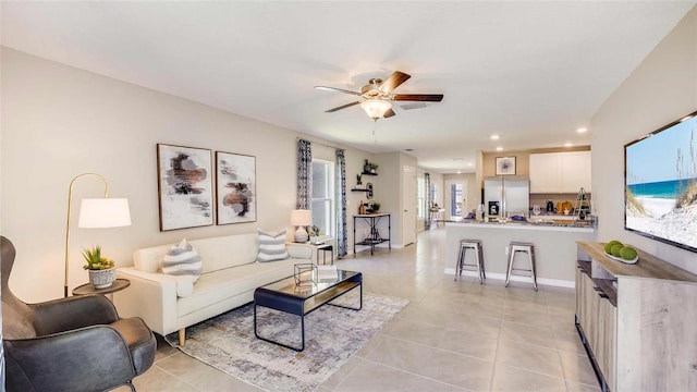 living area featuring light tile patterned floors, recessed lighting, baseboards, and ceiling fan