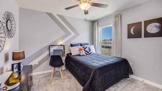 bedroom featuring baseboards, ceiling fan, and carpet flooring