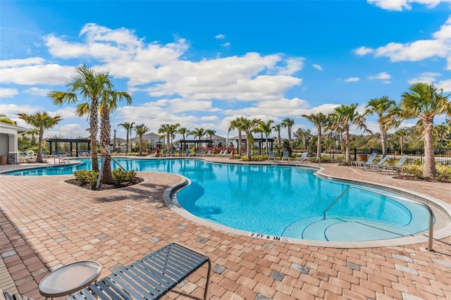 pool with fence and a patio area