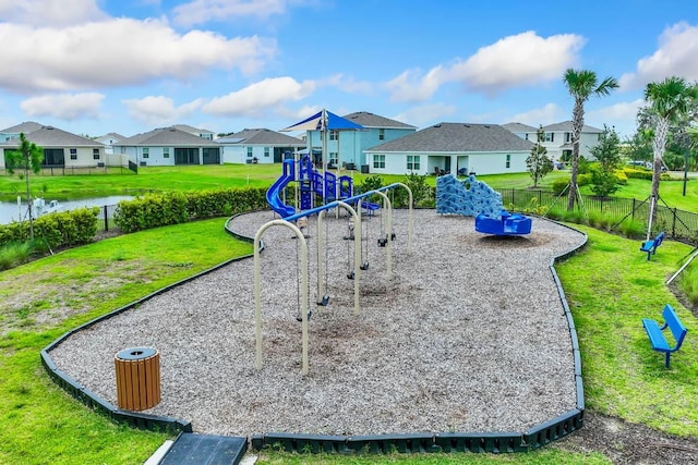 communal playground with a yard, fence, a residential view, and a water view