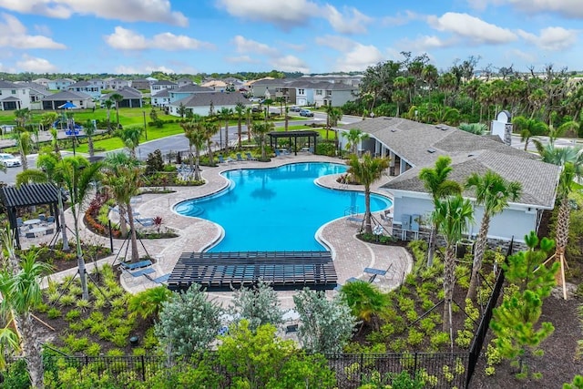 pool featuring a patio area, a residential view, and fence