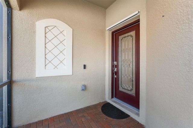 doorway to property with stucco siding