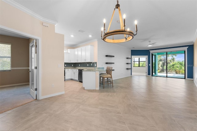 kitchen featuring dishwashing machine, white cabinetry, crown molding, ceiling fan with notable chandelier, and open floor plan