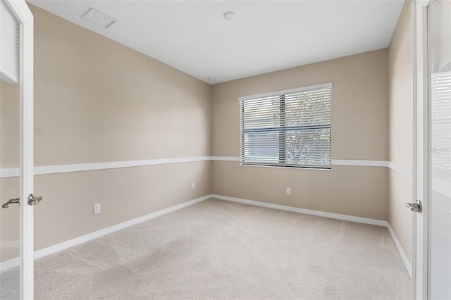 carpeted spare room with baseboards