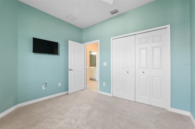 unfurnished bedroom with a ceiling fan, carpet, visible vents, baseboards, and a closet