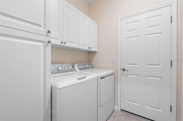 laundry room featuring washer and dryer and cabinet space