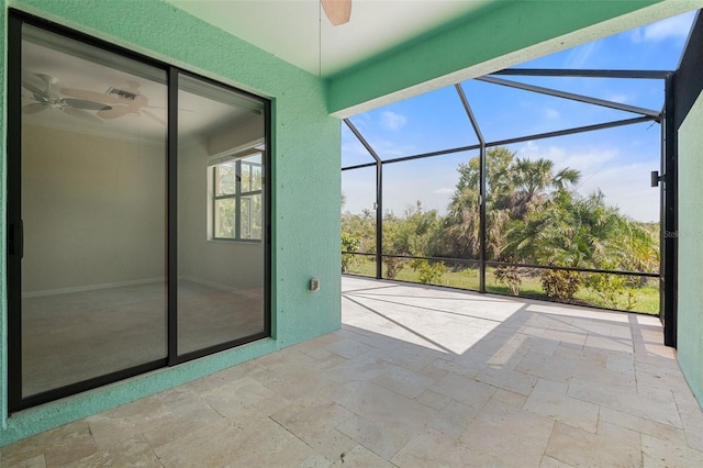 unfurnished sunroom featuring a ceiling fan and visible vents