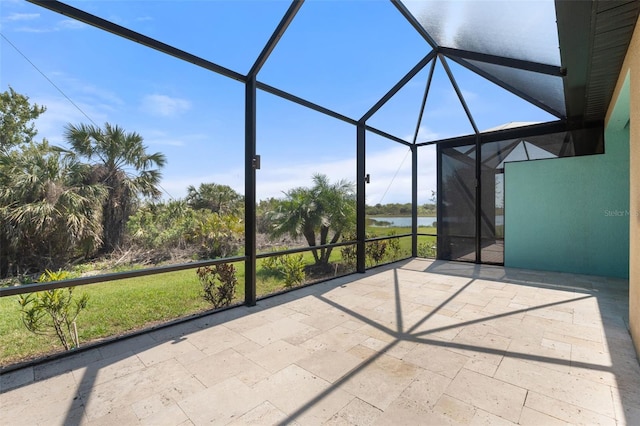 unfurnished sunroom featuring a water view