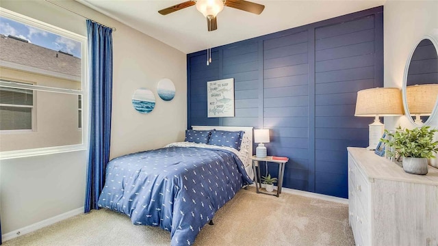 bedroom featuring ceiling fan, baseboards, and carpet