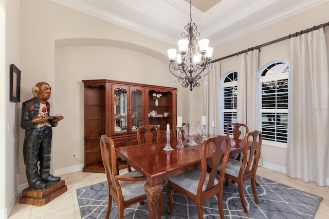 dining space featuring baseboards, an inviting chandelier, light tile patterned flooring, crown molding, and a raised ceiling