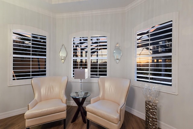 living area featuring baseboards, wood finished floors, and ornamental molding