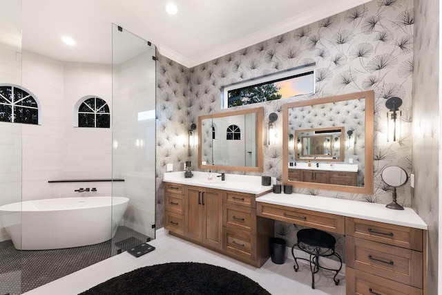 full bath with a freestanding tub, ornamental molding, tile walls, wallpapered walls, and vanity