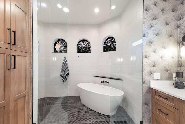 full bathroom featuring wallpapered walls, recessed lighting, tile patterned flooring, a freestanding bath, and vanity