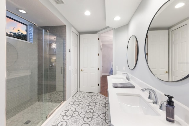 bathroom with tile patterned flooring, recessed lighting, a shower stall, and a sink