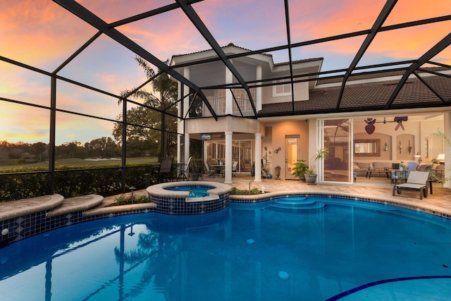 view of swimming pool with a patio, a pool with connected hot tub, and a lanai