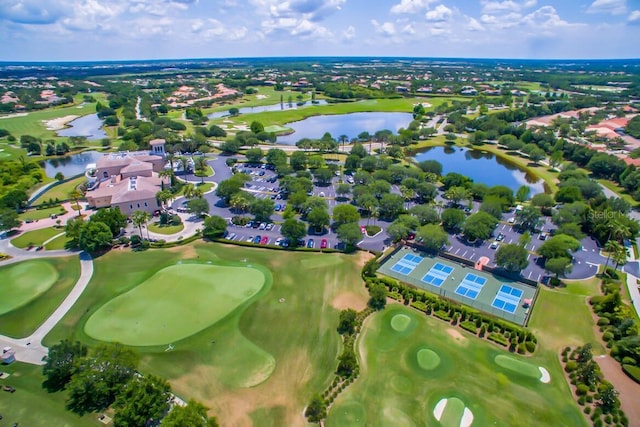 birds eye view of property featuring view of golf course and a water view