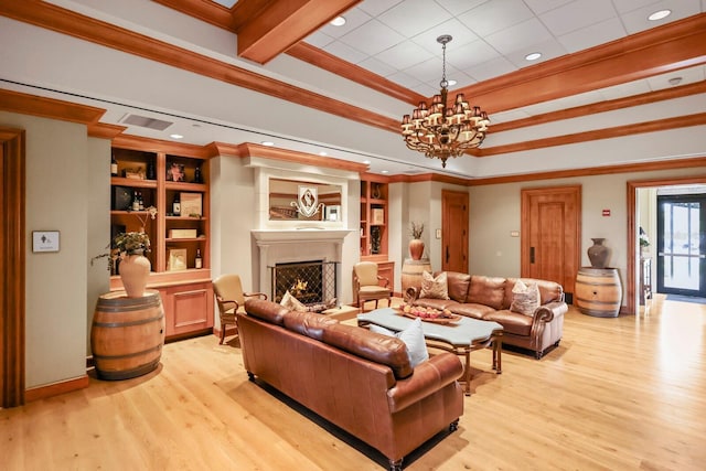 living area featuring a chandelier, a warm lit fireplace, ornamental molding, and light wood finished floors