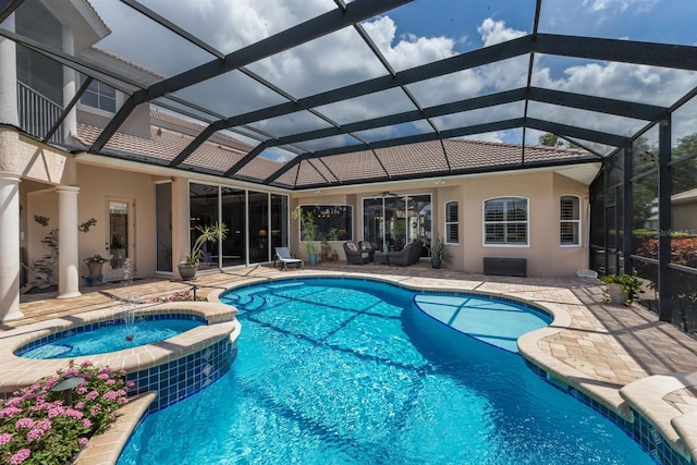 13635 Legends Walk Ter, Lakewood Ranch, FL 34202 - view of pool featuring a patio area, a pool with connected hot tub, glass enclosure, and outdoor lounge area